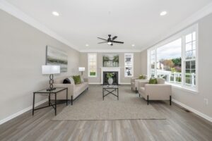 decorated family room with couch and two chairs next to fireplace